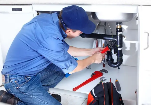 CentraHeat plumber is fixing the sink drain pipe in Swindon