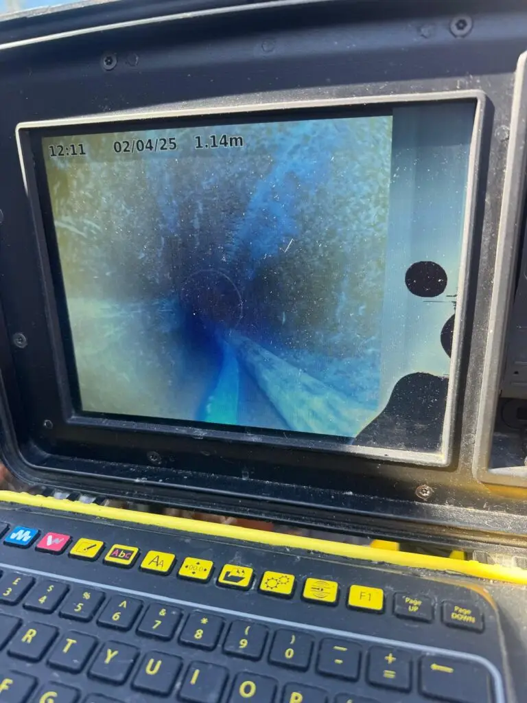 CCTV inspection screen showing the inside of a residential drain pipe