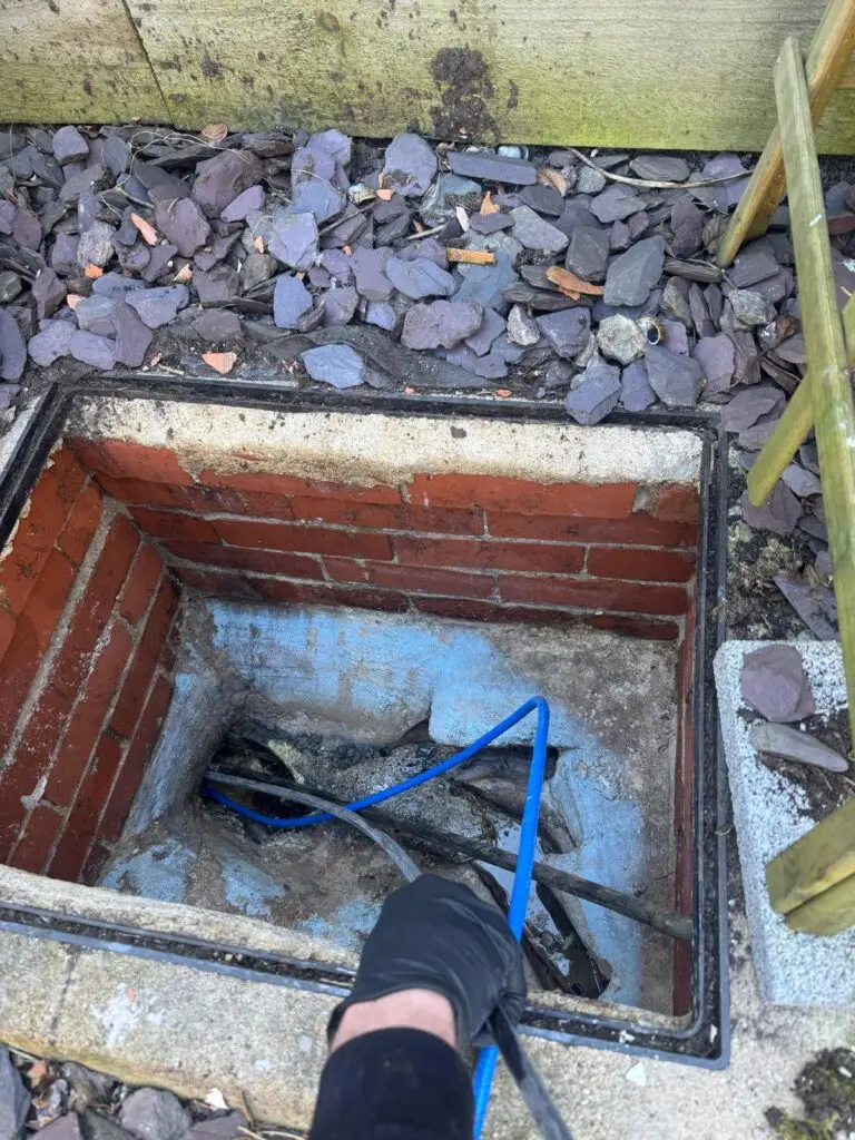 Air line fed into a brick inspection chamber during a CIPP resin drain repair