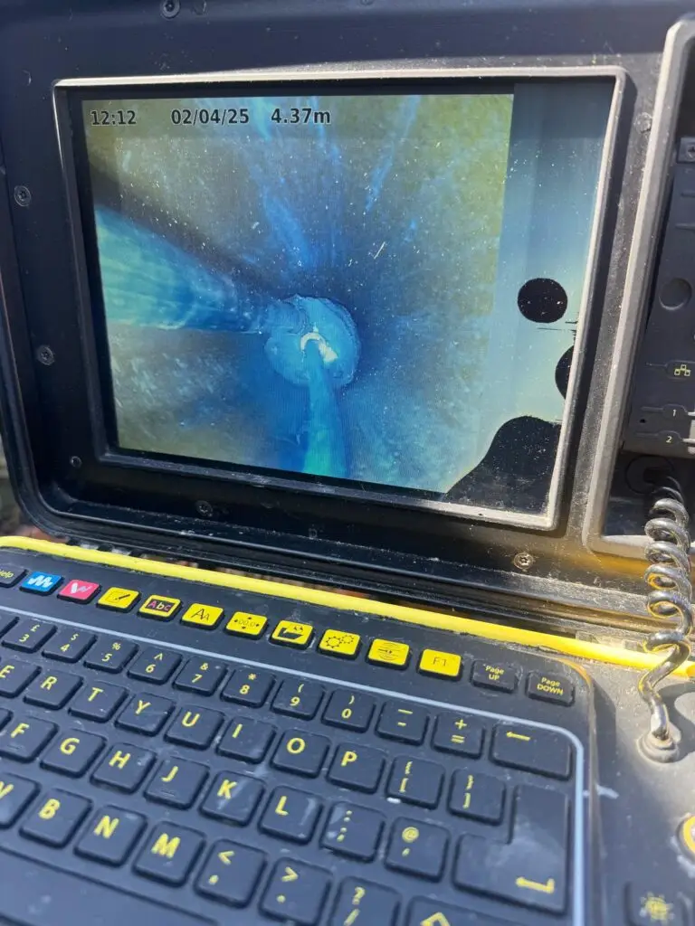 CCTV camera view inside a drain pipe during a no-dig repair, 4.37 metres from the chamber